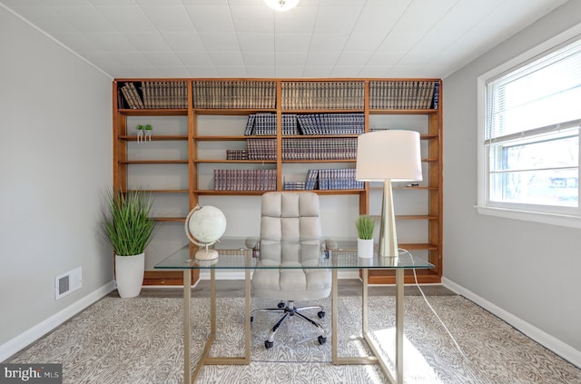 unfurnished office featuring visible vents and baseboards