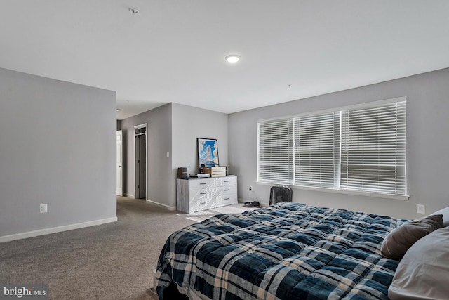 bedroom featuring carpet and baseboards