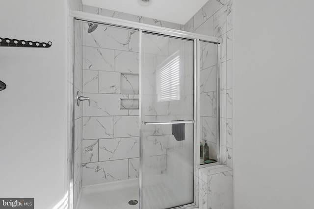 bathroom with a marble finish shower