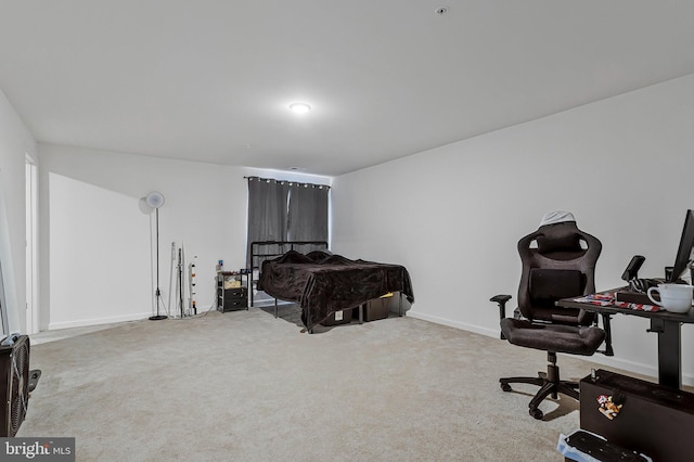 bedroom featuring carpet and baseboards