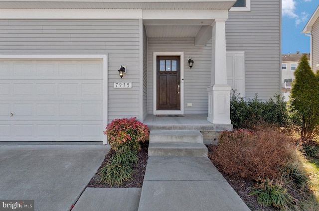 view of exterior entry with a garage