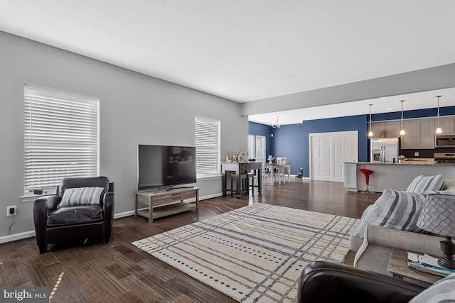 living room featuring dark wood-style floors and baseboards