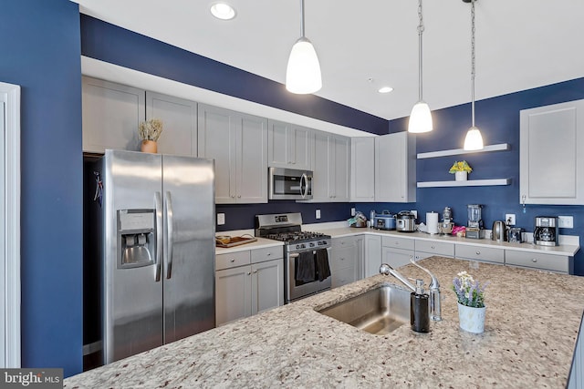 kitchen with stainless steel appliances, a sink, light stone countertops, open shelves, and pendant lighting