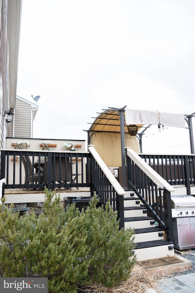 wooden terrace with stairs and area for grilling