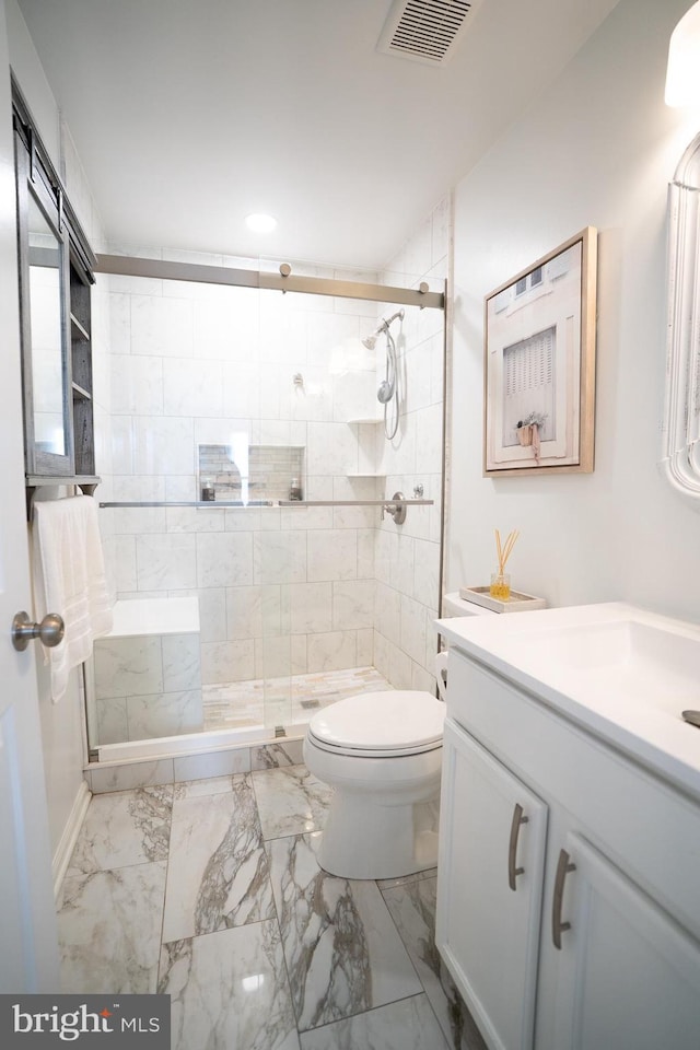 bathroom featuring a shower stall, toilet, visible vents, and marble finish floor