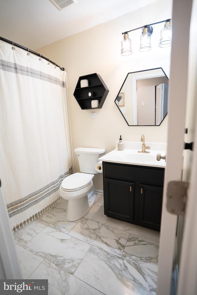 bathroom featuring vanity, a shower with shower curtain, toilet, and marble finish floor