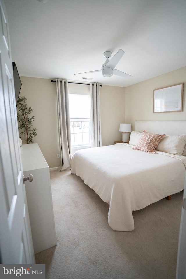 bedroom featuring light carpet and ceiling fan