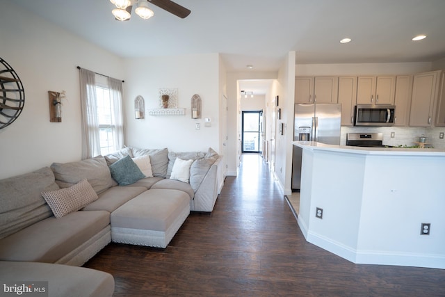 living area with dark wood finished floors, recessed lighting, baseboards, and a ceiling fan