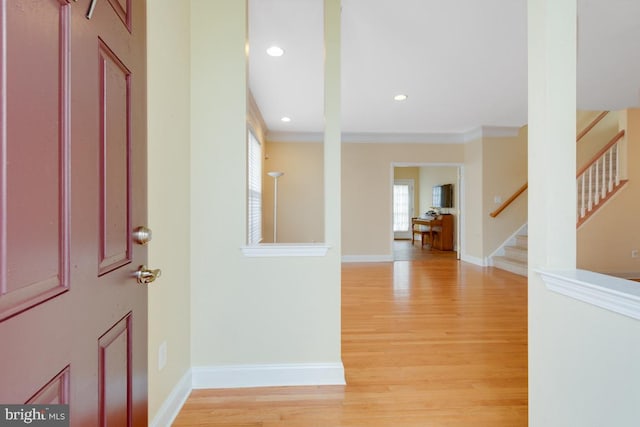 foyer with stairway, baseboards, recessed lighting, ornamental molding, and light wood-style floors