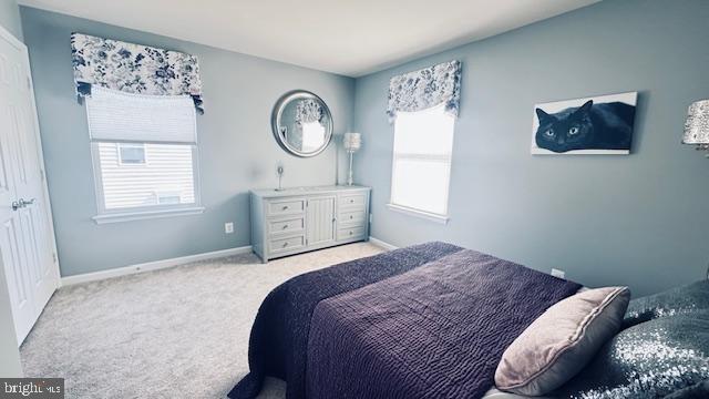 carpeted bedroom with baseboards