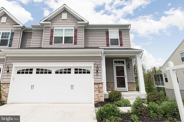 2820 Union Square Rd Unit 5, New Windsor, MD 21776 - view of front of home with stone siding, driveway, an attached garage, and a porch