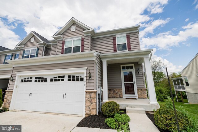 2820 Union Square Rd Unit 5, New Windsor, MD 21776 - view of front of home with stone siding, an attached garage, driveway, and a porch