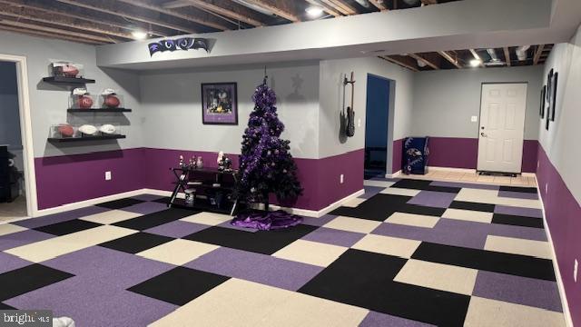 finished basement with tile patterned floors and baseboards