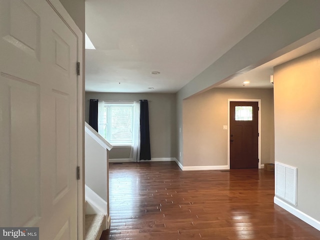 interior space with plenty of natural light, dark wood-type flooring, and visible vents