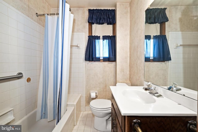 bathroom with vanity, shower / bath combo, tile patterned floors, toilet, and tile walls