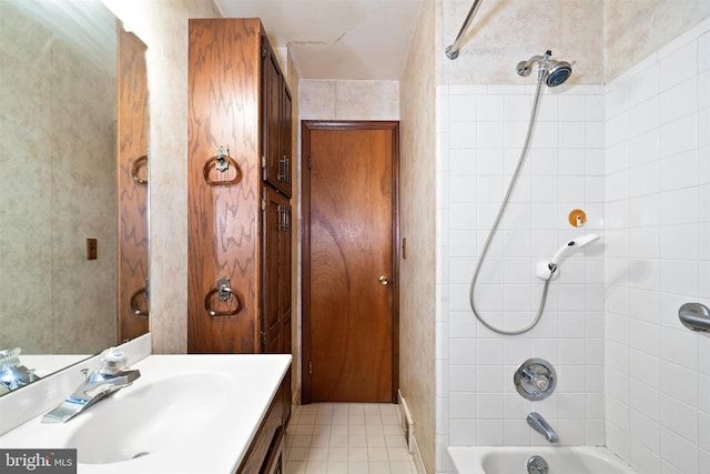 bathroom featuring tile patterned floors, shower / washtub combination, and vanity