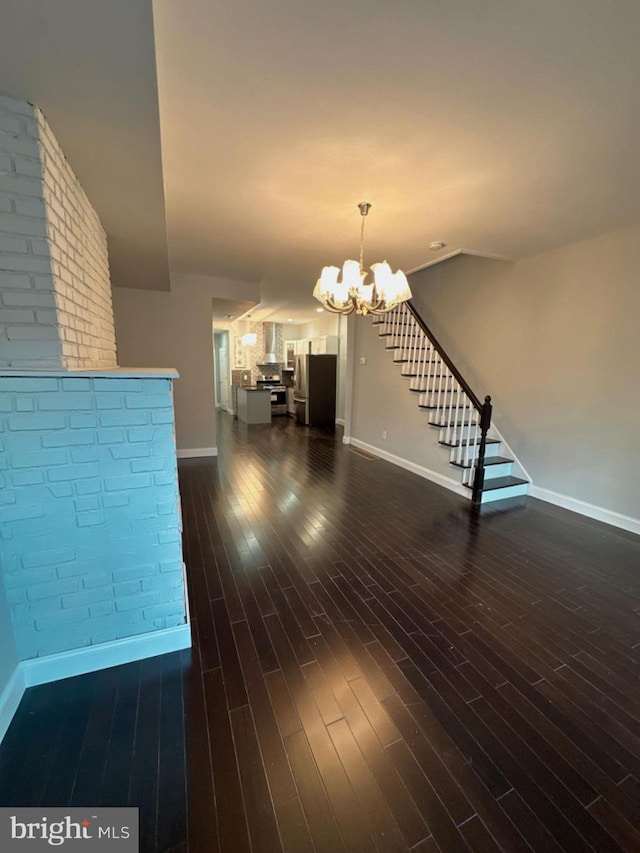 interior space with stairs, dark wood-type flooring, a chandelier, and baseboards