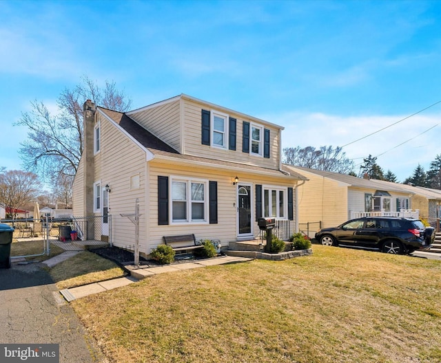 view of front of property with a front yard and fence