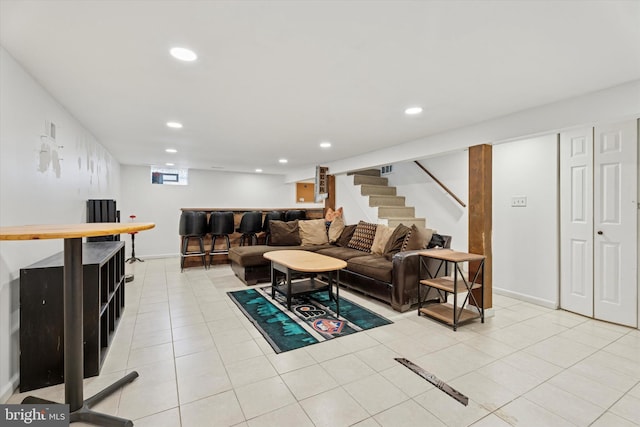 living room featuring recessed lighting, a bar, stairs, and light tile patterned floors