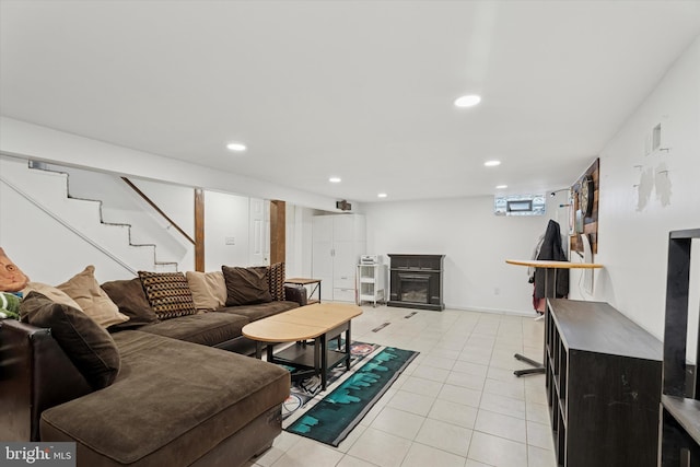 living area with visible vents, light tile patterned flooring, recessed lighting, stairs, and a glass covered fireplace