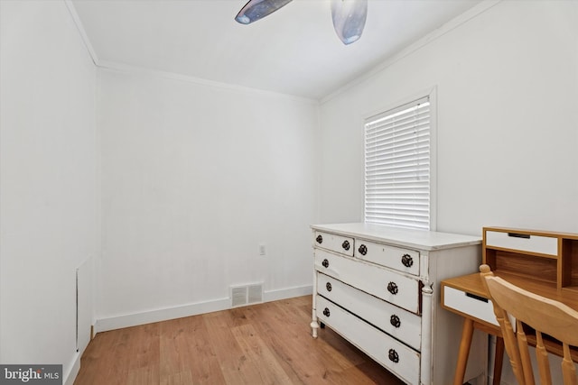 bedroom with visible vents, light wood-style flooring, baseboards, and ornamental molding