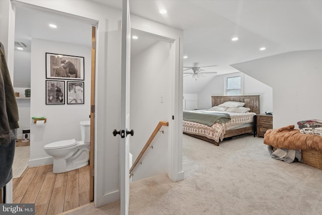 bedroom featuring recessed lighting, light wood-type flooring, light carpet, and vaulted ceiling