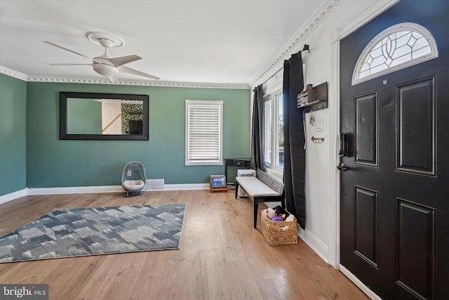 entryway with baseboards, wood finished floors, and a ceiling fan