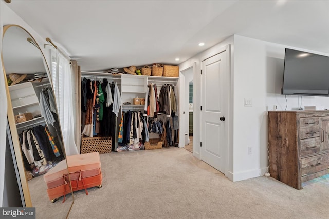 spacious closet featuring lofted ceiling and carpet flooring