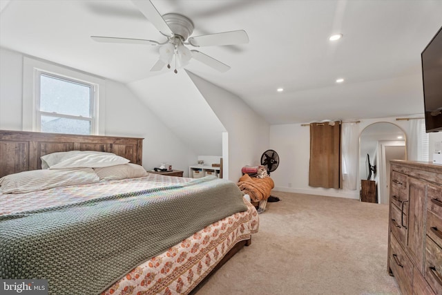 bedroom featuring light colored carpet, lofted ceiling, recessed lighting, arched walkways, and a ceiling fan