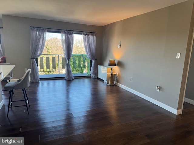 living area featuring dark wood-style floors and baseboards