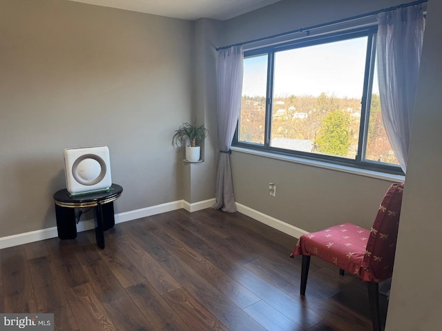 living area featuring dark wood-style floors and baseboards