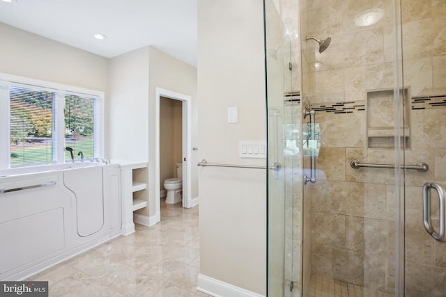 bathroom with baseboards, toilet, and a shower stall