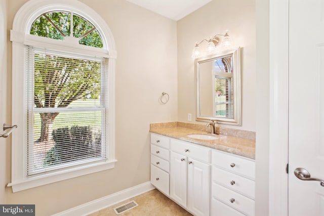 bathroom with tile patterned floors, visible vents, vanity, and baseboards