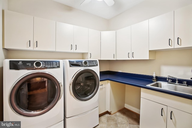 washroom with ceiling fan, washer and clothes dryer, cabinet space, and a sink