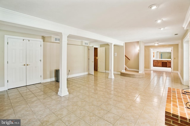 finished basement with light tile patterned floors, stairway, baseboards, and visible vents