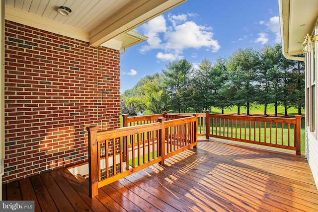 wooden terrace featuring a yard