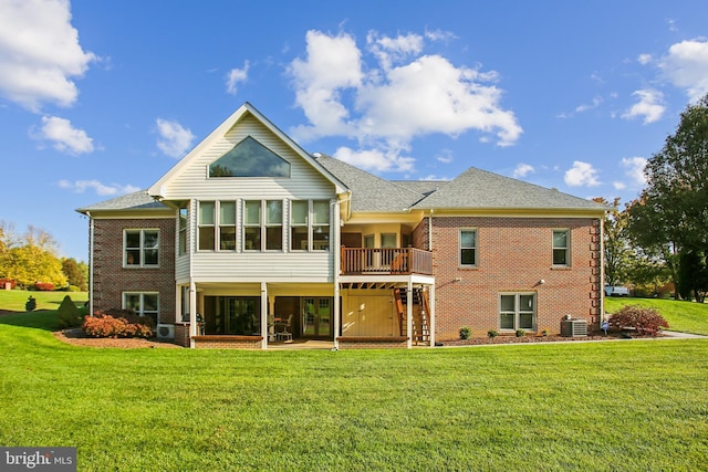 rear view of property with brick siding, stairway, and a lawn