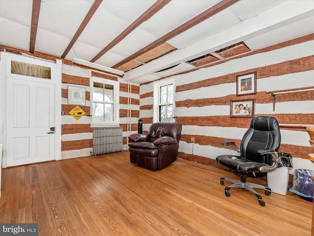 office area featuring beamed ceiling, radiator, and wood-type flooring