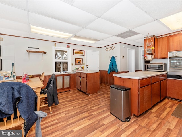 kitchen featuring brown cabinetry, a peninsula, and stainless steel appliances