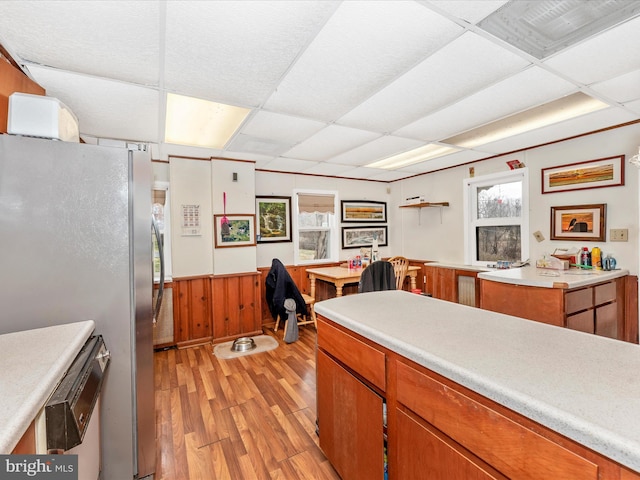 kitchen with light countertops, freestanding refrigerator, and a paneled ceiling