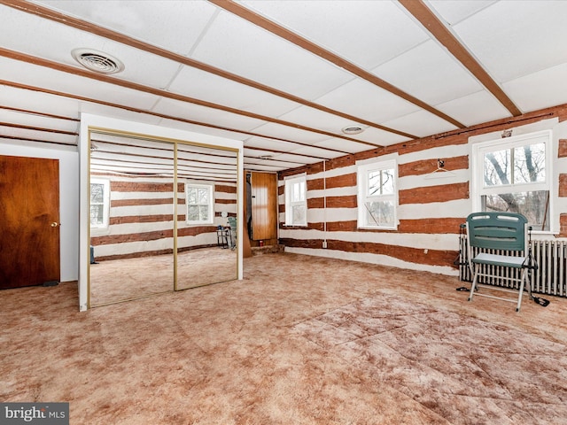 interior space with radiator heating unit and visible vents