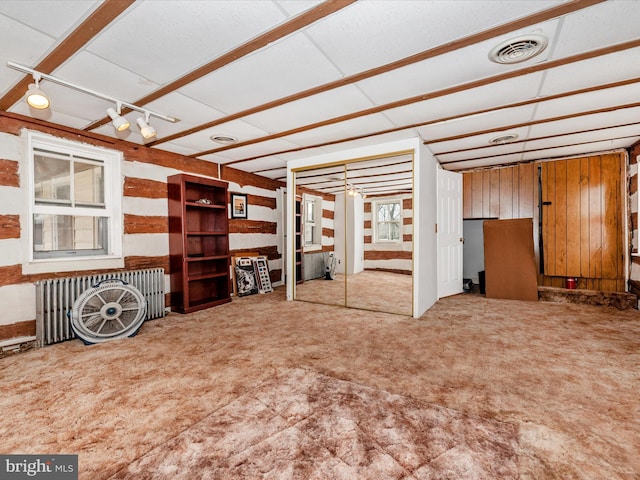 interior space with radiator heating unit and visible vents