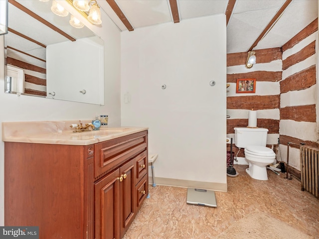 bathroom featuring radiator, toilet, and vanity