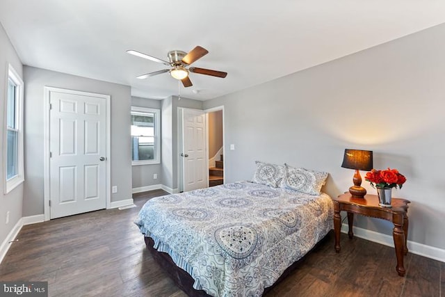 bedroom with baseboards, dark wood finished floors, and a ceiling fan