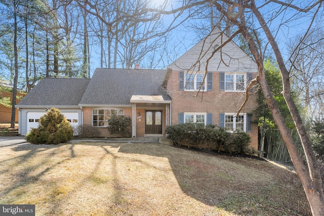 view of front of home with brick siding, a shingled roof, a front lawn, a chimney, and a garage