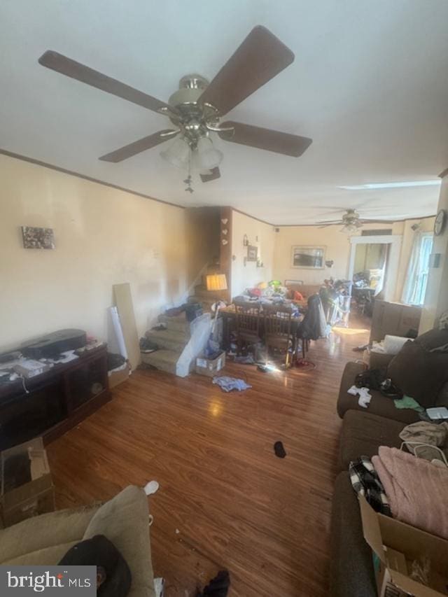 living room featuring a ceiling fan and wood finished floors