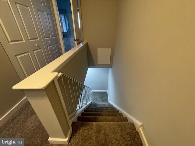 stairs featuring carpet and baseboards