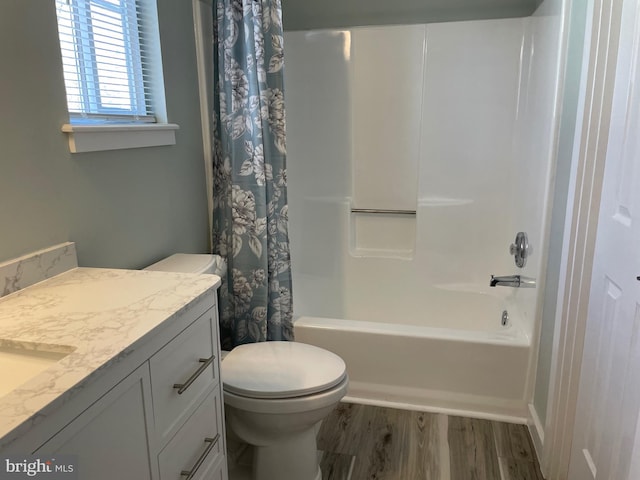 bathroom with vanity, wood finished floors, shower / bath combo, and toilet