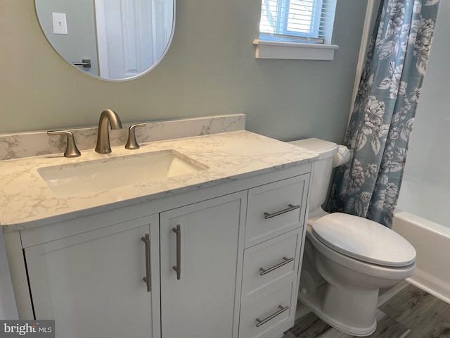 full bath with shower / bath combination with curtain, toilet, vanity, and wood finished floors