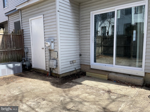 entrance to property featuring a patio and central AC